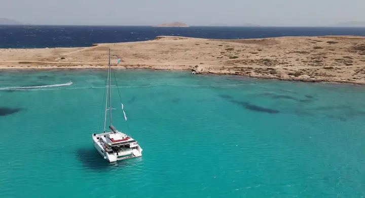 Makani catamaran moving through the Cyclades under sail.