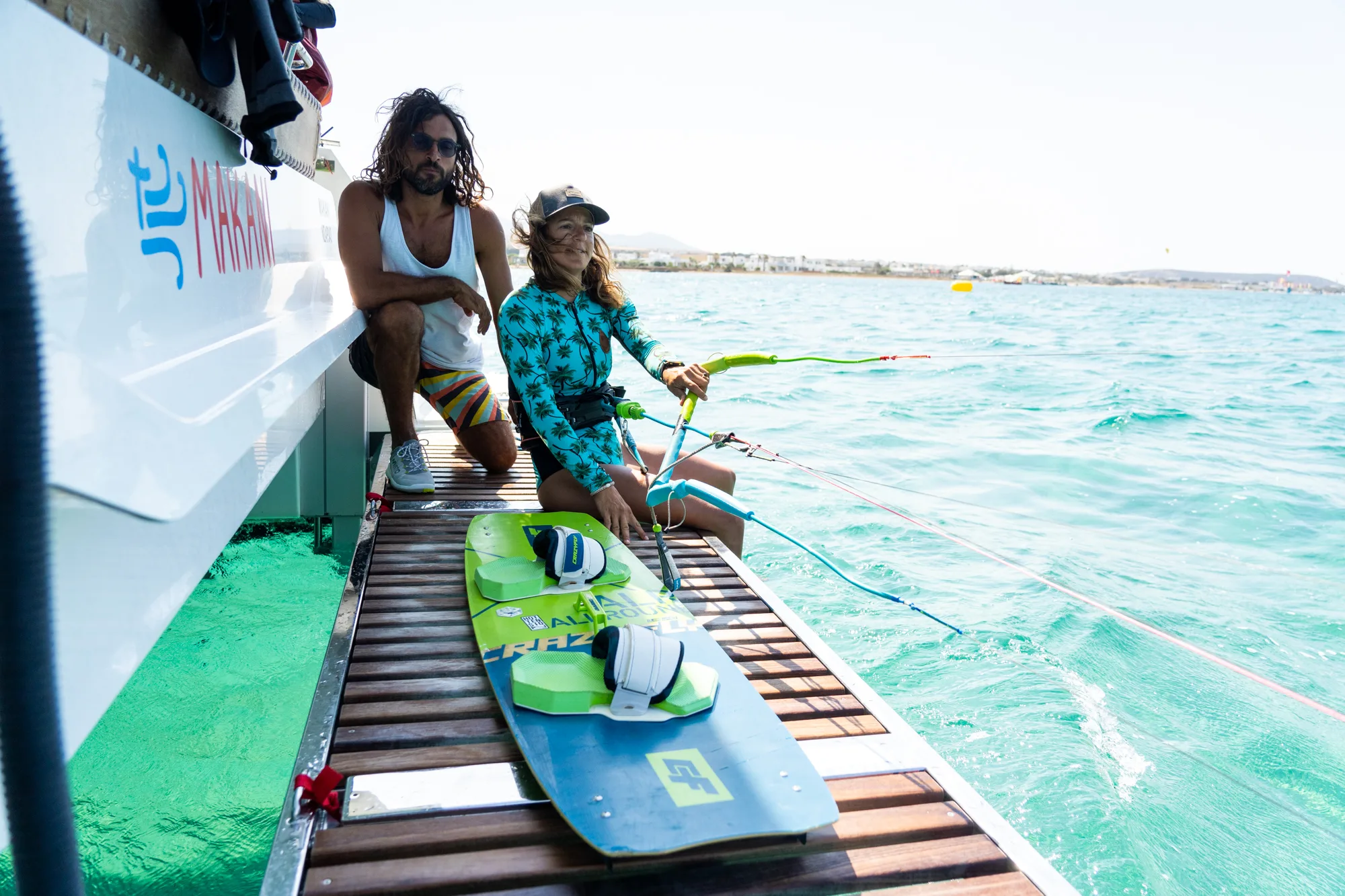 Kitesurfer launching directly from the Makani catamaran's stern platform.