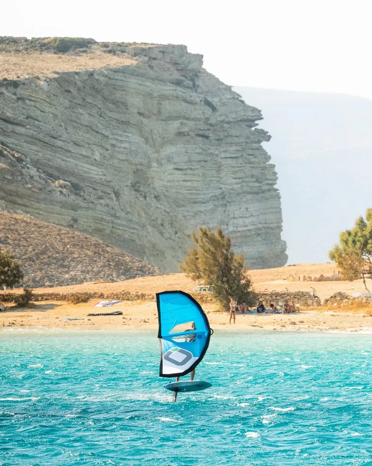 Makani guests and the Cyclades coastline during a summer sailing trip.
